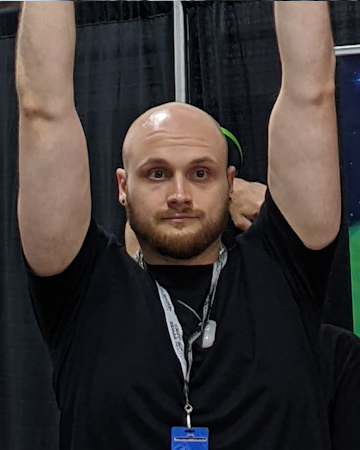 Photograph of YenDoor member Chris holding his arms up