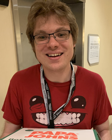 Photograph of YenDoor member Josh holding pizza