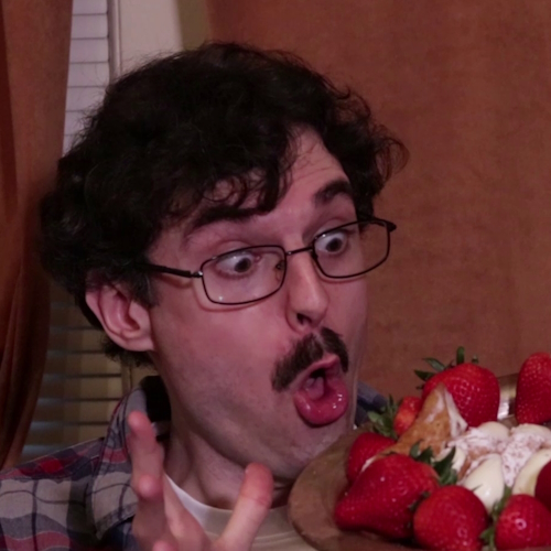 Photo of Peter holding plate of strawberries.